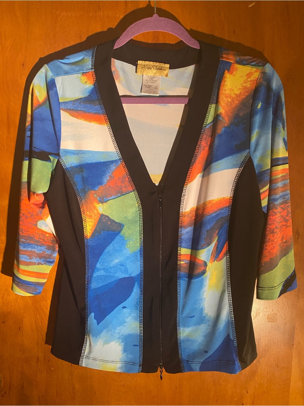 Kristin Crenshaw vibrant abstract zip-front jacket style top,